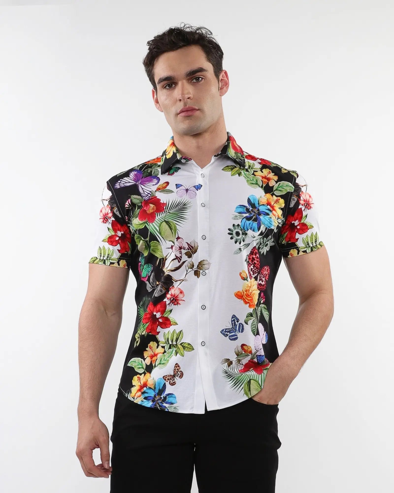 Floral border print stretch knit short-sleeved shirt with vibrant tropical floral and butterfly motifs on black and white