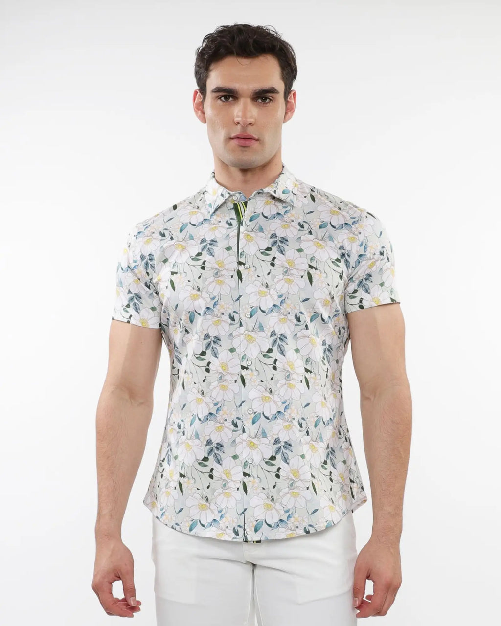 A man wearing a white floral print stretch knit short-sleeved shirt with green and yellow patterns