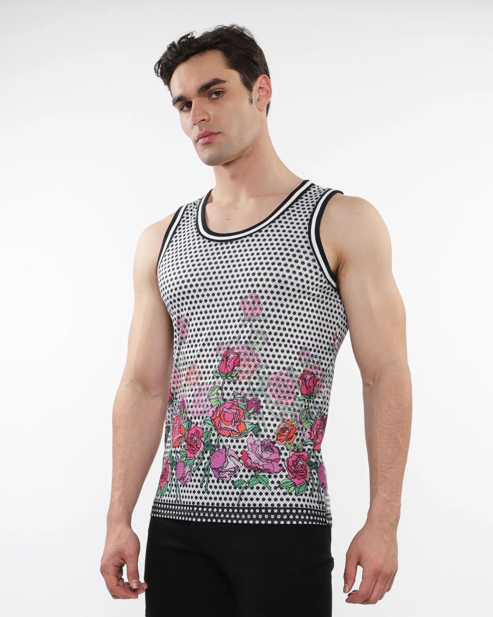 A men’s sleeveless floral printed mesh tank top with pink and red roses on black and white polka dot base with stripe ribbing