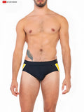 Folsom swim brief featuring black swim trunks with bold yellow side panels in a sleek modern design