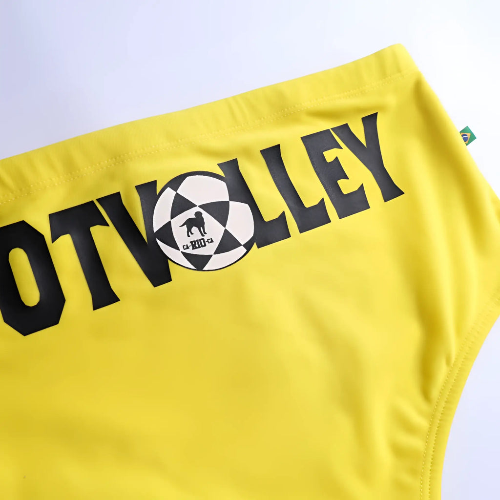 Bright yellow footvolley sunga traditional cut swimwear with bold black lettering and checkered soccer ball dog graphic
