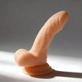 Frisky 4-inch realistic flesh-toned silicone dildo with textured detail and a sturdy suction cup base.