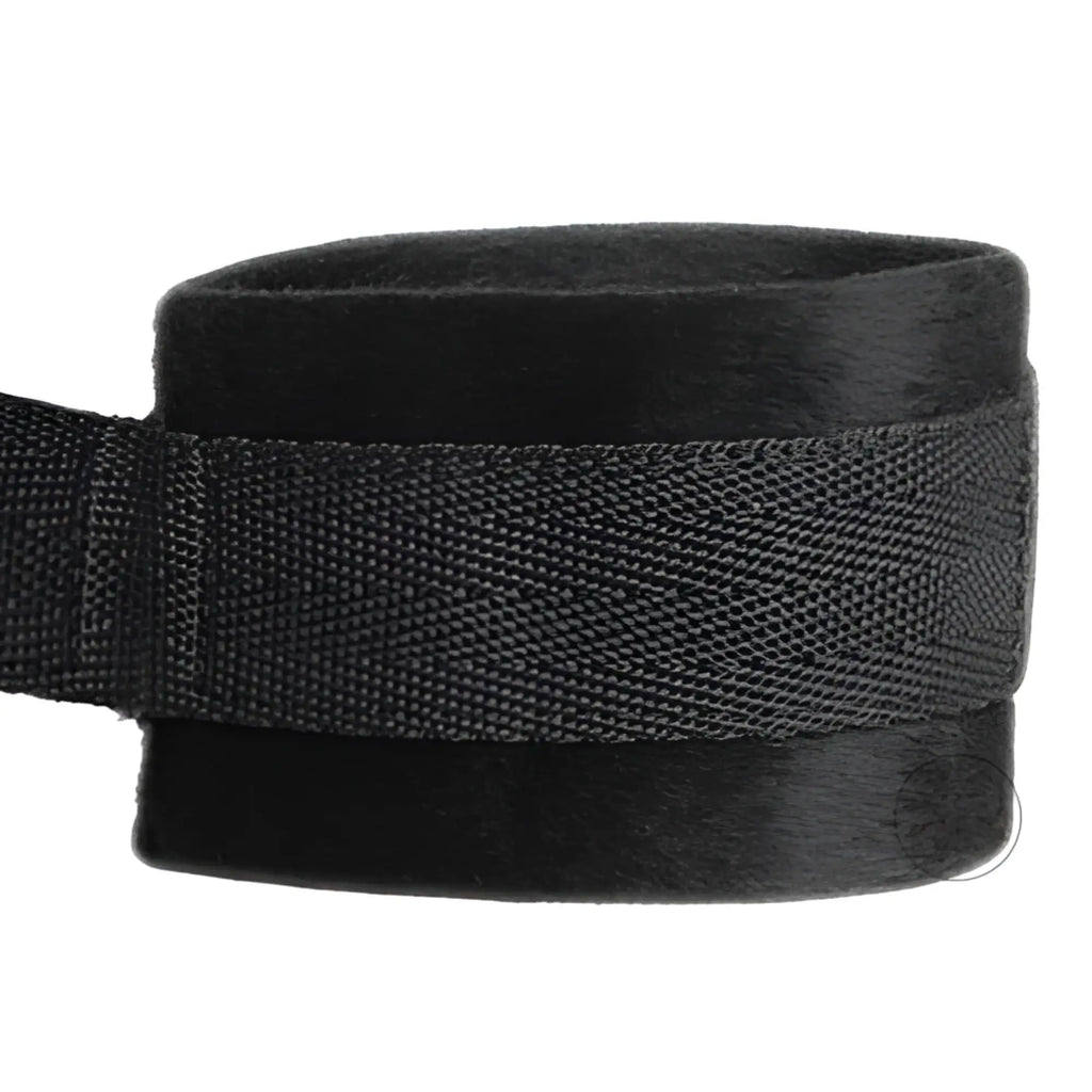 Frisky Beginner Fleece Bed Restraints Kit: A close-up of a soft, black fleece-lined restraint cuff with webbing strap.