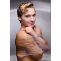 A man with blond hair poses with Frisky Clear Bondage Tape wrapped securely around his bare upper body and arms.