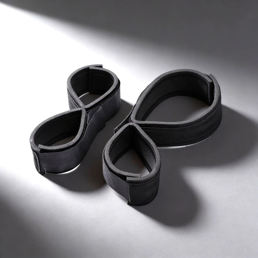 Frisky Double Leg and Arm Restraints: Two black, adjustable foam-padded figure-eight loops on a gray background.