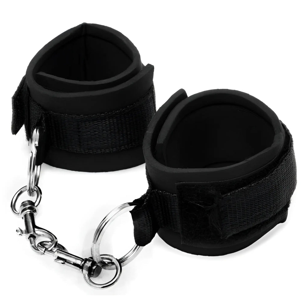 Frisky Heavy Duty Neoprene Cuffs: A pair of black, padded, velcro-fastening cuffs linked by a silver metal chain.