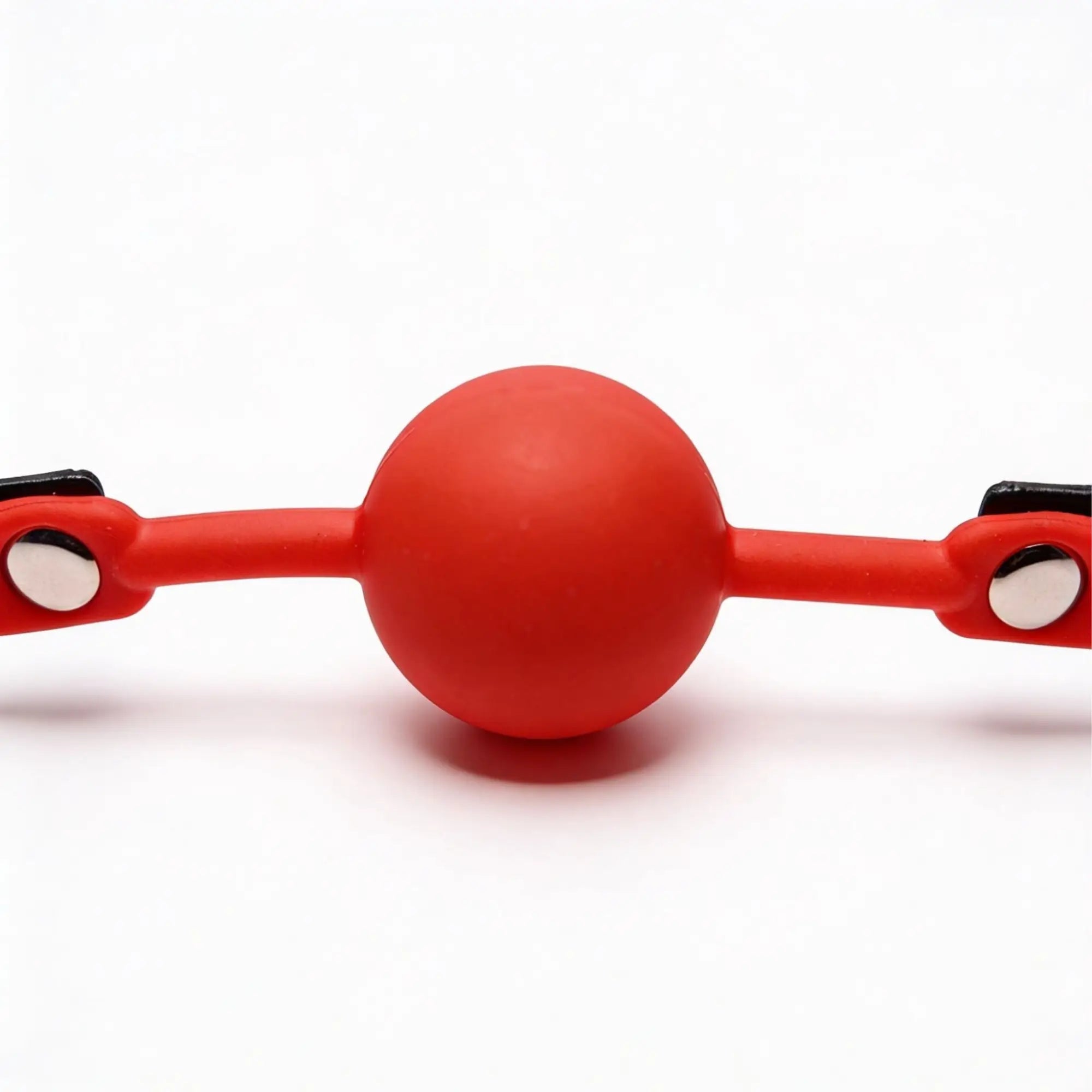 Frisky The Silicone Comfort Ball Gag in bright red, featuring a round ball with integrated straps and silver metal studs.
