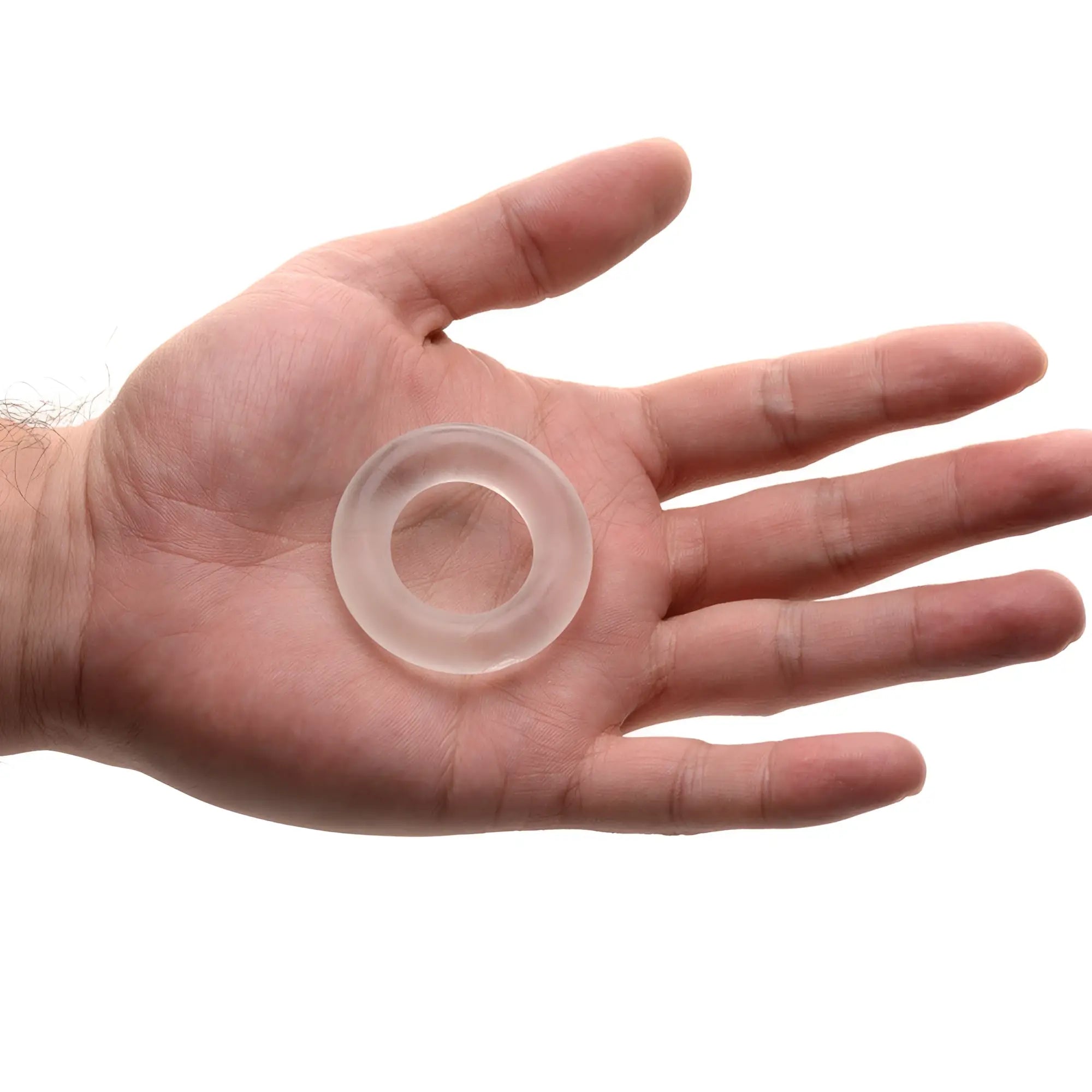 Frisky Super Stretch Universal Cock Ring: a clear, flexible silicone ring held in an open palm against a white background.