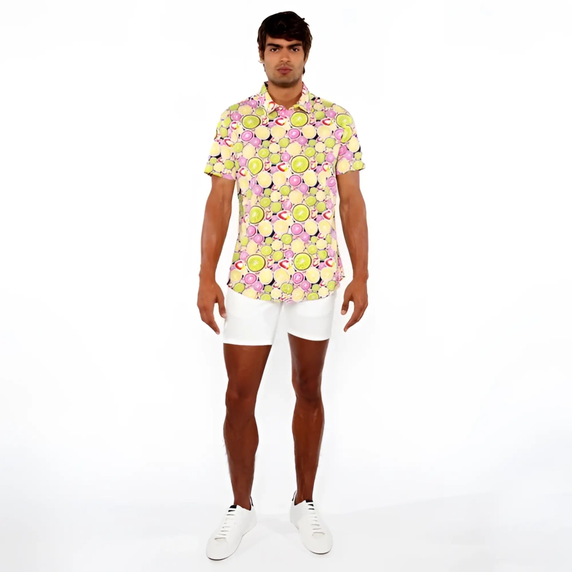 A vibrant fruits print stretch knit shirt with sliced lemons and limes pattern in yellow green pink and black on light background