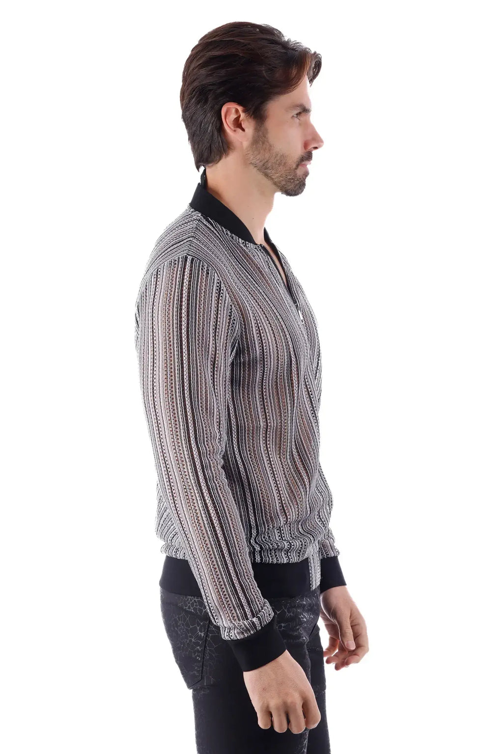 A man wearing a funky novelty bomber jacket with black and white stripes and ribbed cuffs