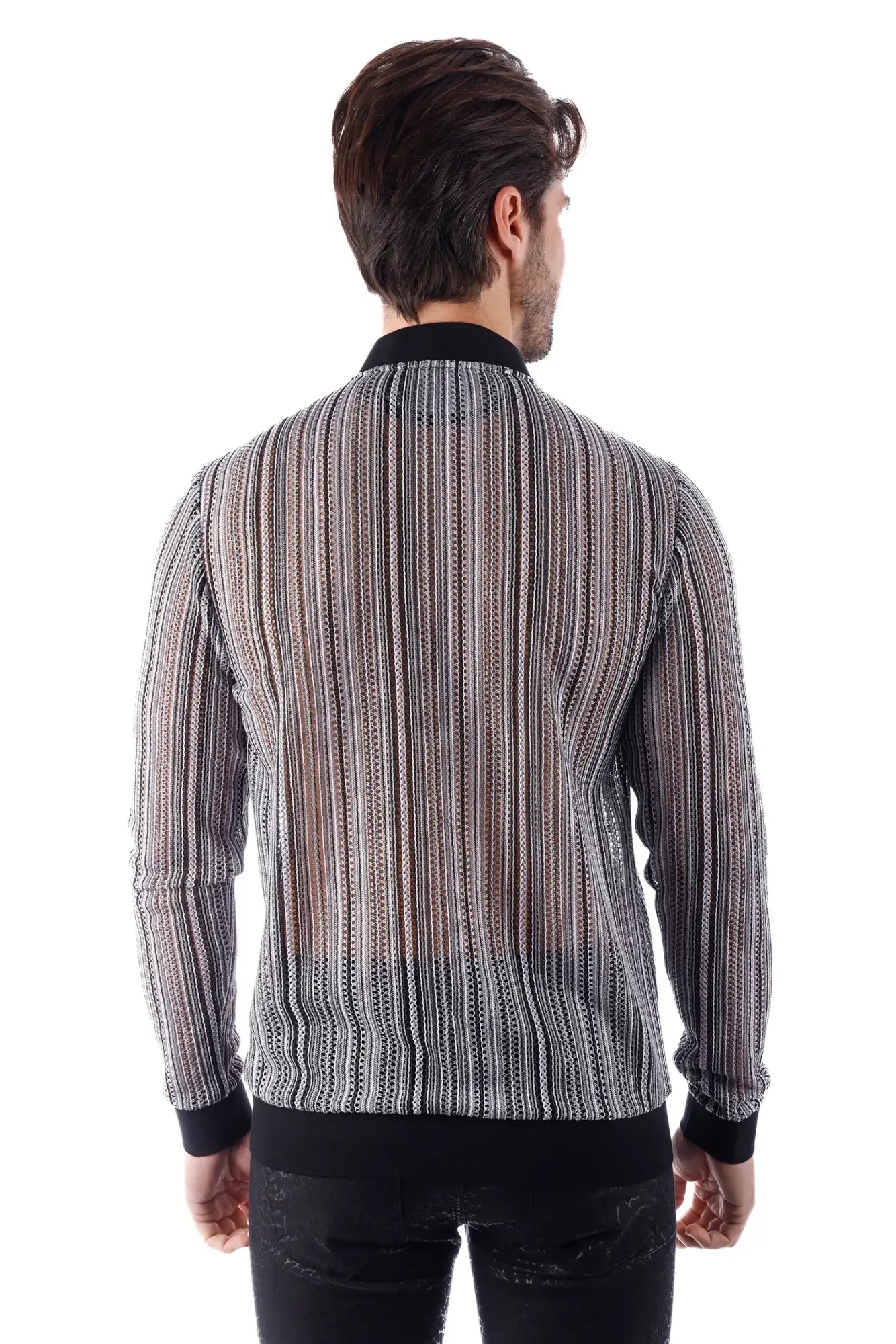 A man wearing a black and white striped long-sleeved sheer patterned funky novelty bomber jacket