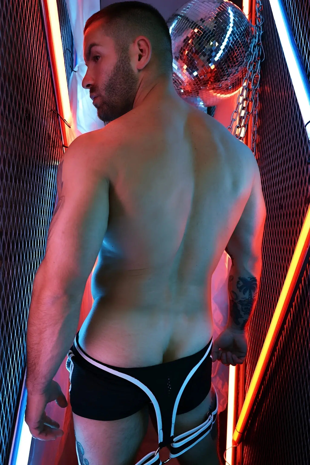 Futura sluterall black and white striped harness-style briefs with sleek modern design shown from the back side