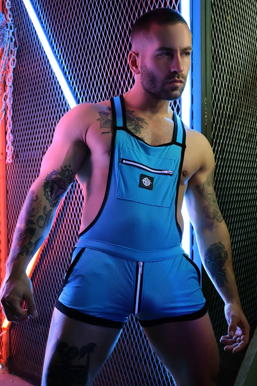 Futura sluterall blue mesh overalls with black trim and front zipper pocket featuring a small logo patch