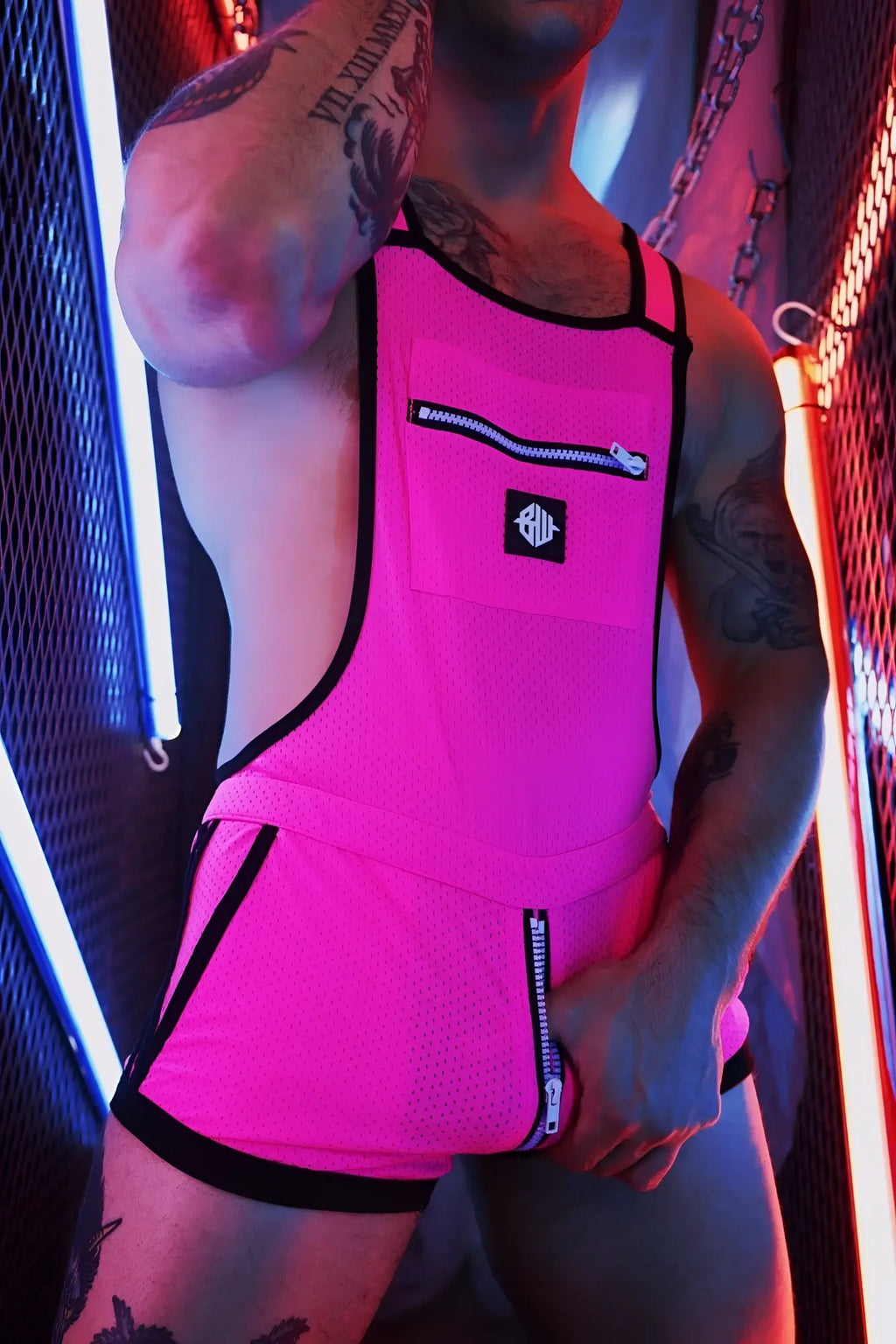 Futura Sluterall bright pink mesh overalls with black trim zippers and a small logo patch on the chest
