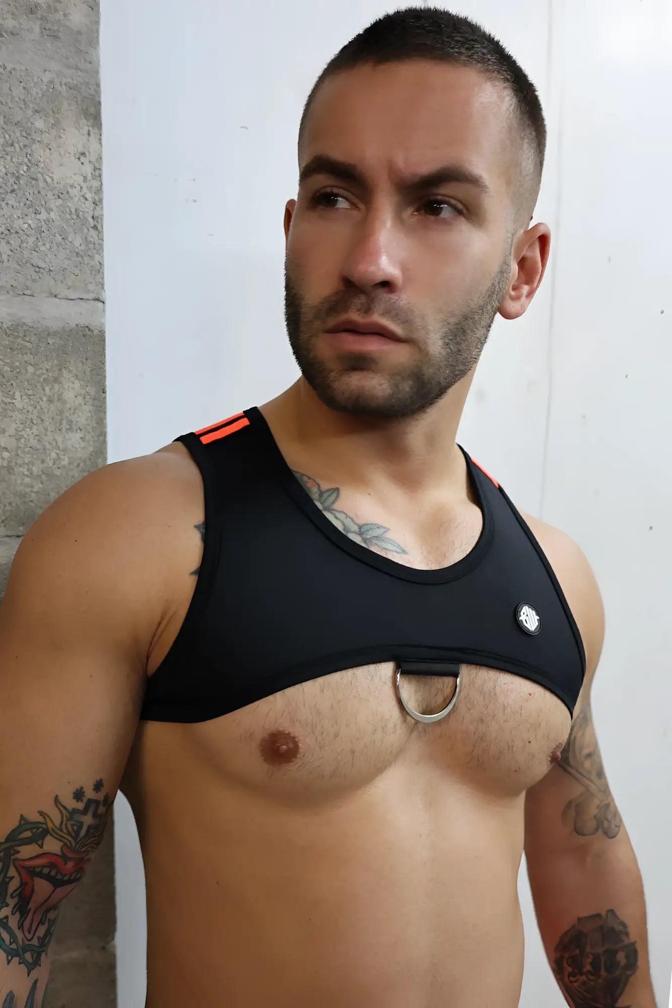 Black athletic tank top futura tank harness with orange trim and silver metal ring at center for active wear