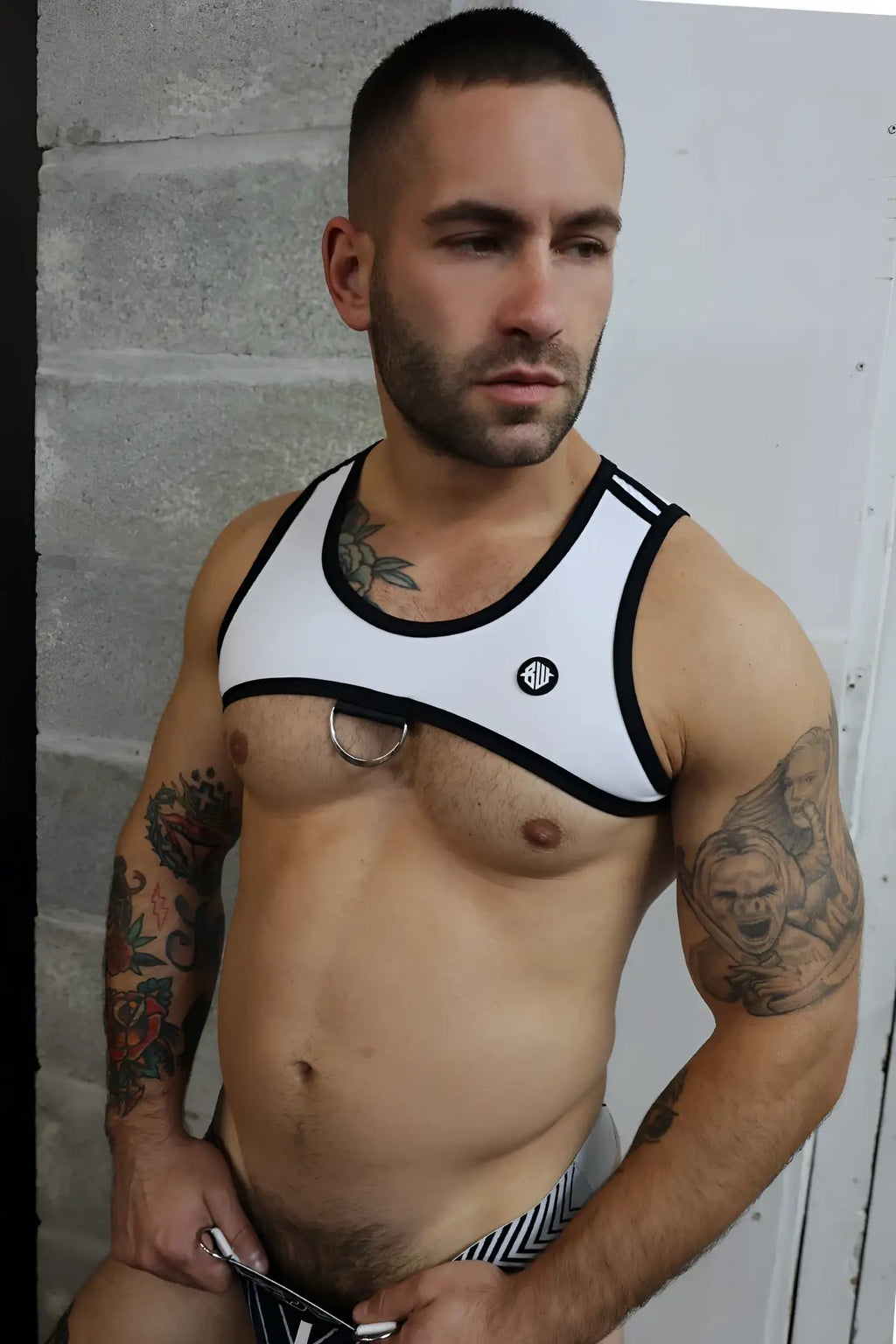 White and black futura tank harness with circular metal ring at center made from durable fabric for stylish wear
