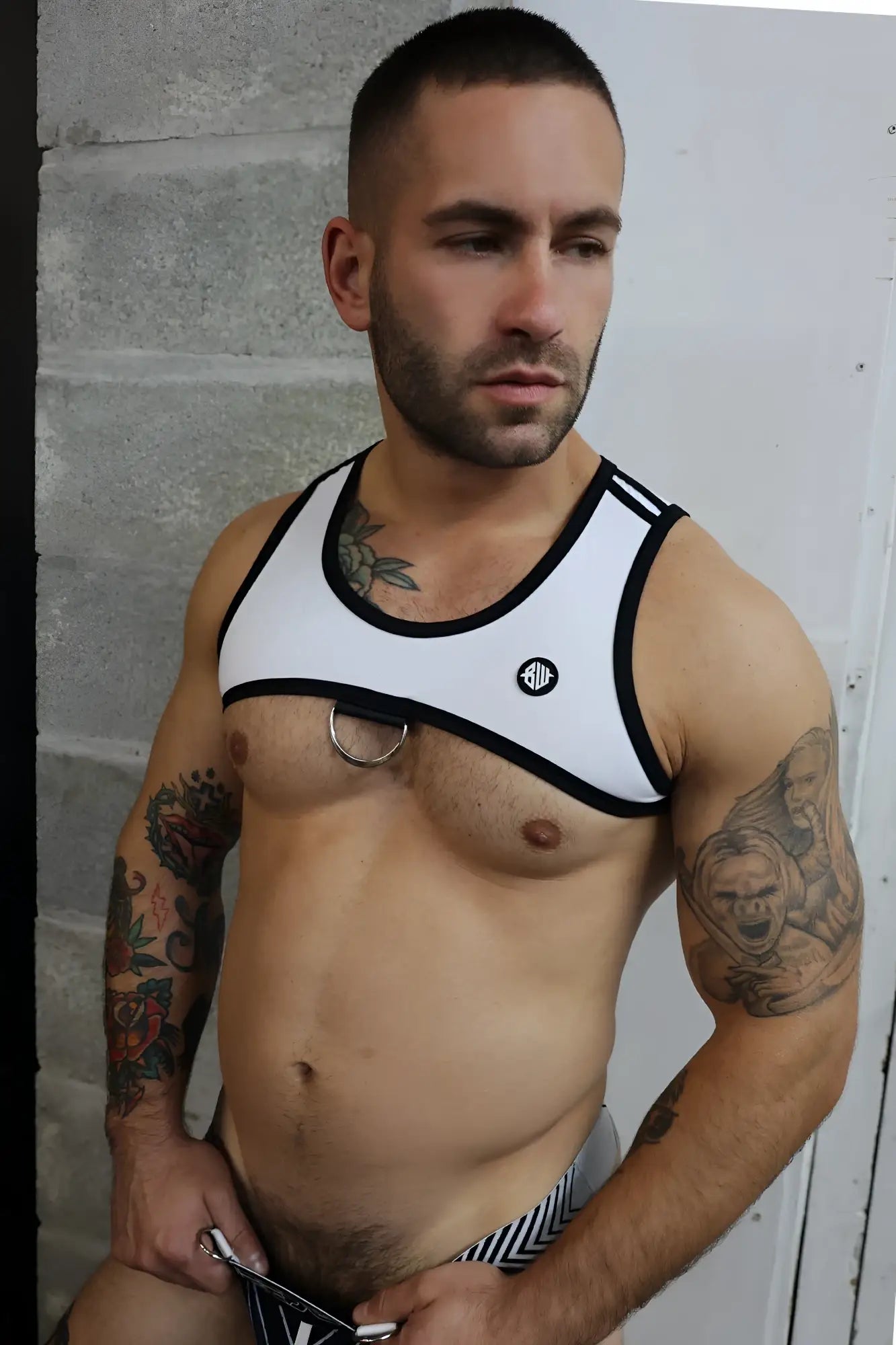 White and black futura tank harness with circular metal ring at center made from durable fabric for stylish wear