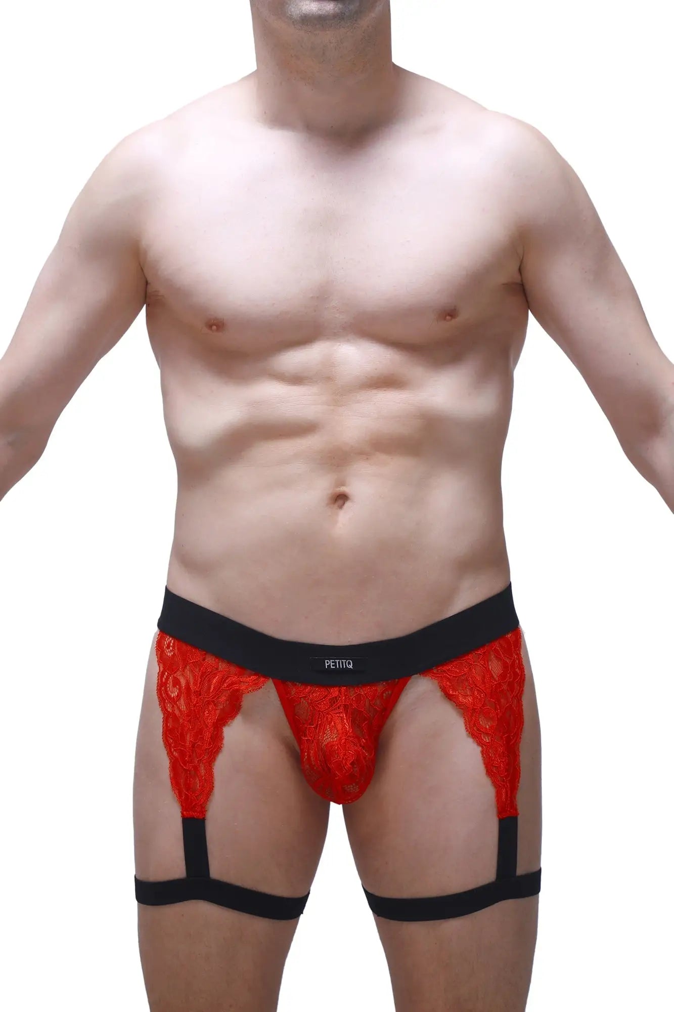 Red lace g-string briefs with black elastic waistband and leg straps featuring a bold patterned design