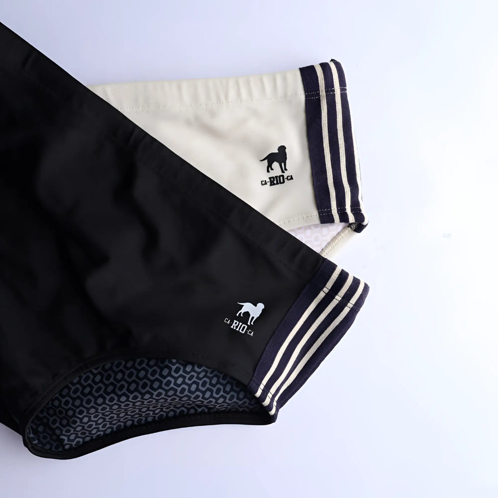 Black and cream galão preto sunga designer swim shorts with striped cuffs and dog logo embroidered on waistband