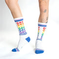 White cotton crew socks with rainbow gay text and blue toe heel and cuff accents for pride and casual wear