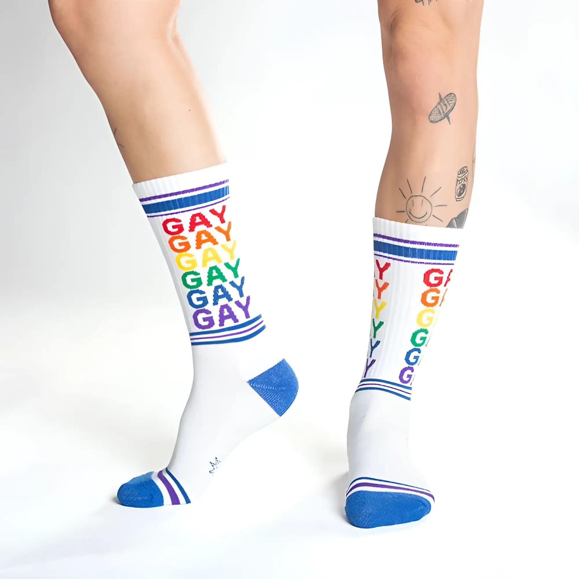 White cotton crew socks with rainbow gay text and blue toe heel and cuff accents for pride and casual wear
