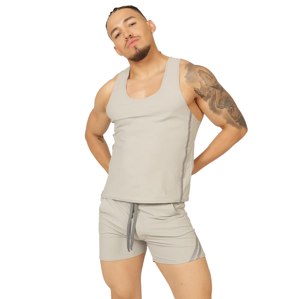 A man wearing a gigo club gray tank sleeveless light gray tank top with subtle side seams and matching shorts with drawstring waistband