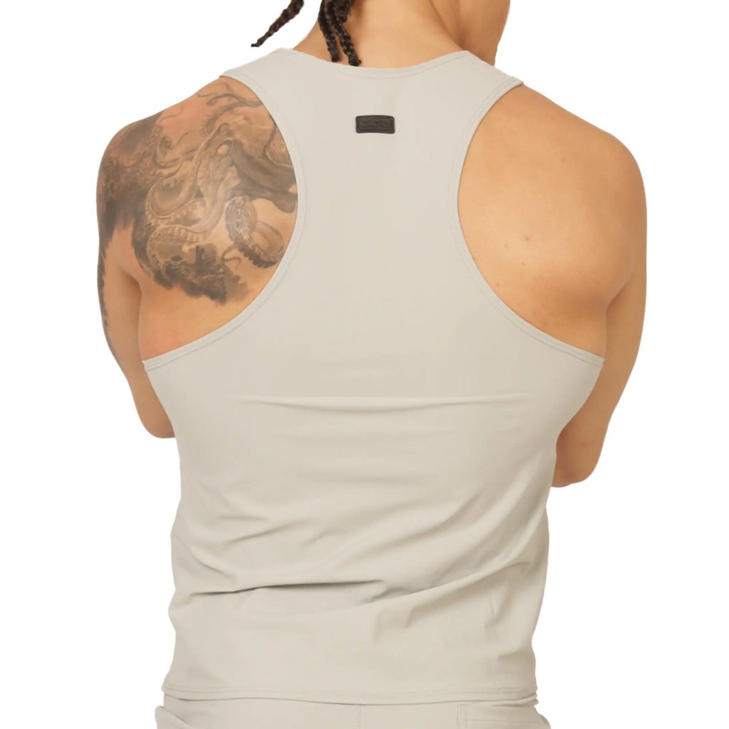 A sleek off-white racerback tank top with minimalist design and small black gigo club brand tag at the neckline