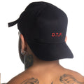 Gigo D.T.F. black baseball cap featuring red embroidered d.t.f. logo and adjustable fabric tie on the back side
