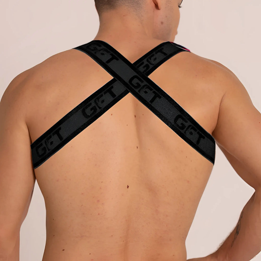 Black gigo fetiche harness back view featuring cross-back straps with get branding in leather material