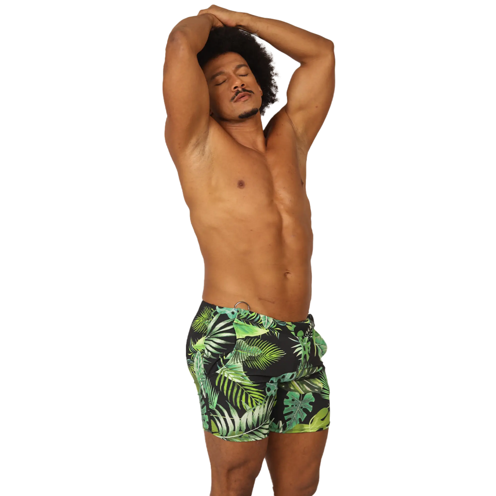 Men’s black swim trunks with vibrant green and lime tropical leaf pattern from Gigo Forest Beachwear