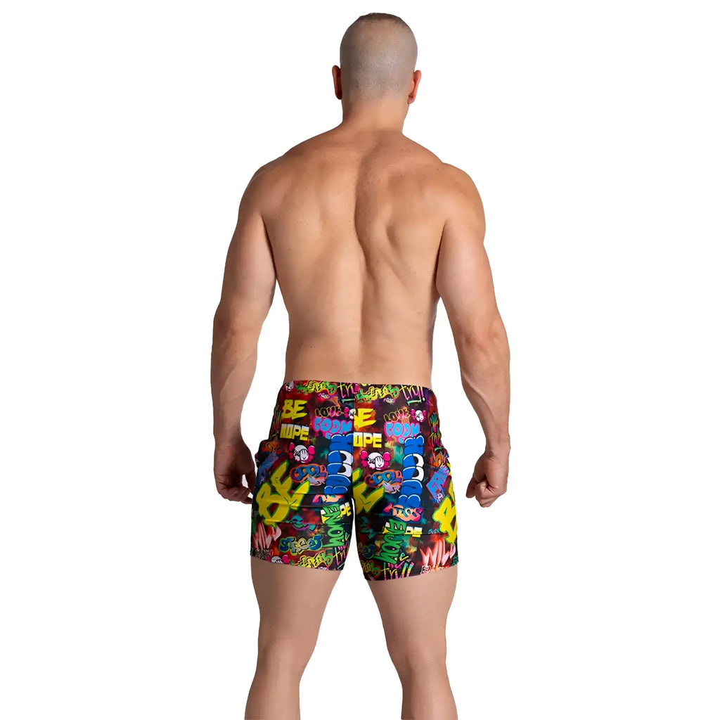 Vibrant graffiti-patterned men’s swim trunks in bold colors with playful street art design from Gigo Graffiti Beachwear