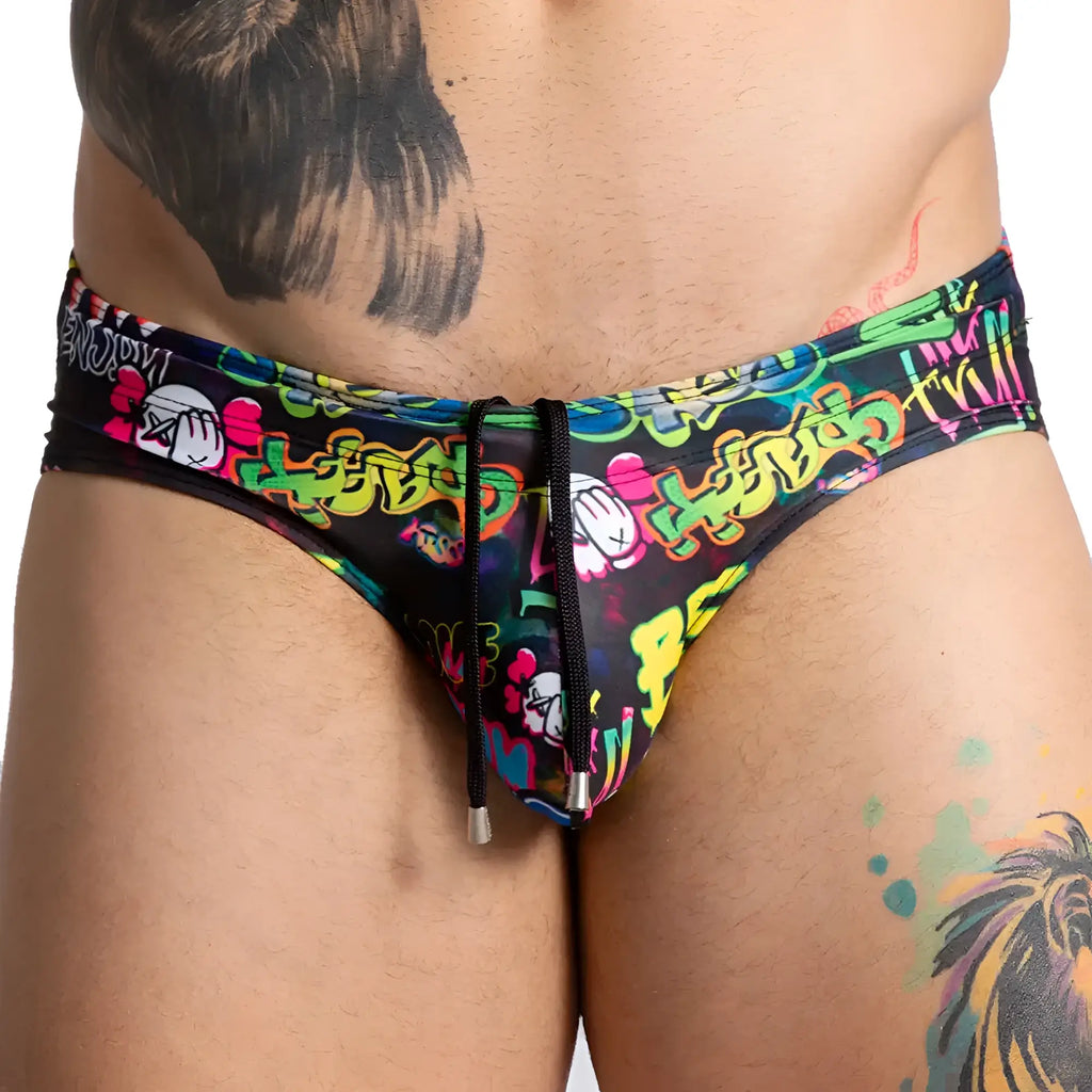 Vibrant graffiti-patterned gigo swim brief in black with neon yellow pink and green designs for summer wear