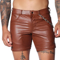 Brown faux leather fitted shorts featuring a button fly, belt loops, and a detachable silver chain detail at the hip.