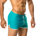 Turquoise athletic shorts with white trim and drawstring waistband from gigo hotenc green beachwear collection