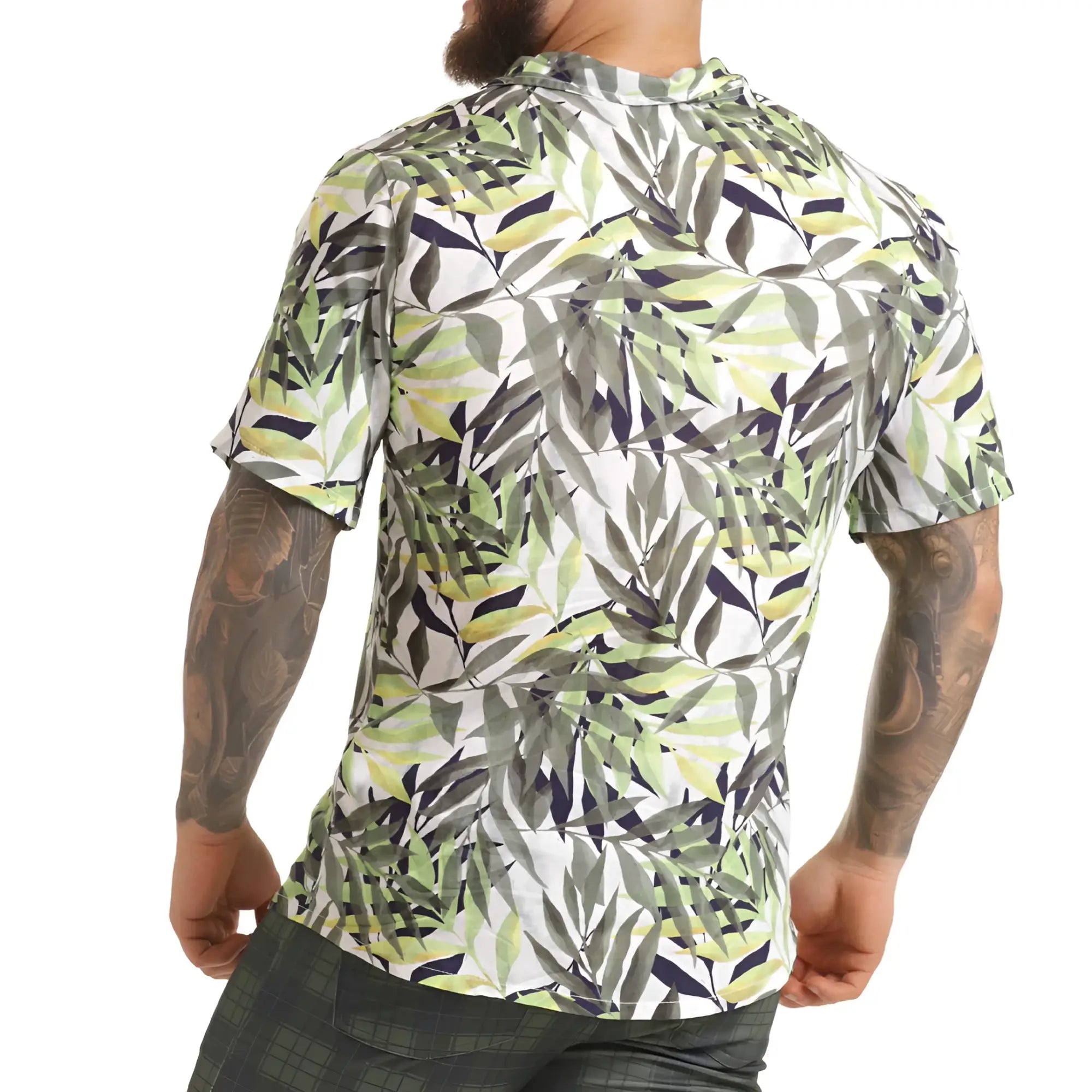 A men’s short-sleeved button-up gigo jungle shirt with vibrant green gray and navy tropical leaf pattern on white background
