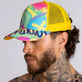 Vibrant graffiti-style gigo neon yellow caps trucker hat with yellow mesh back and bold pink blue green purple paint splatter design