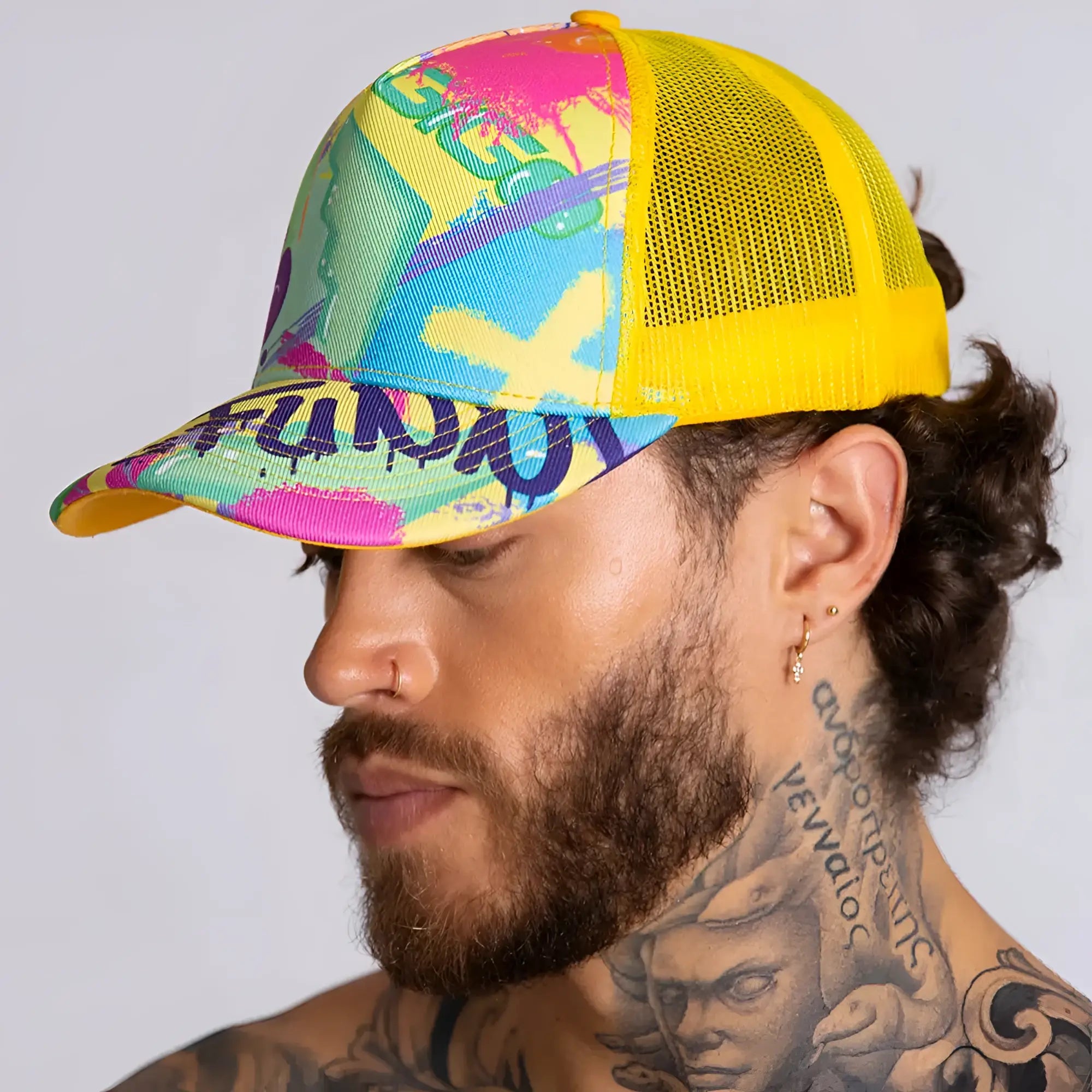 Vibrant graffiti-style gigo neon yellow caps trucker hat with yellow mesh back and bold pink blue green purple paint splatter design