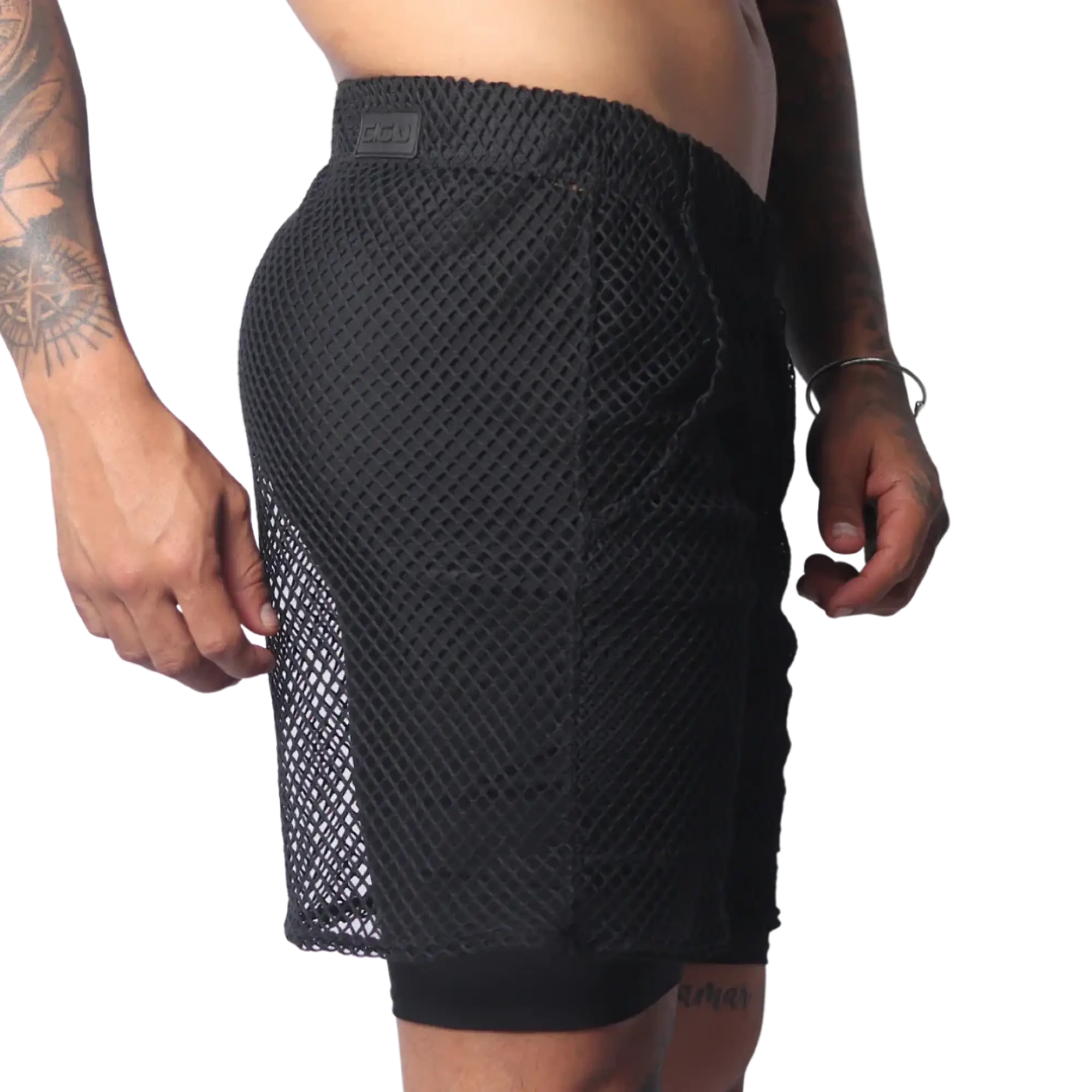 Black athletic shorts in a large-grid fishnet material with a solid inner layer and a branded elastic waistband.
