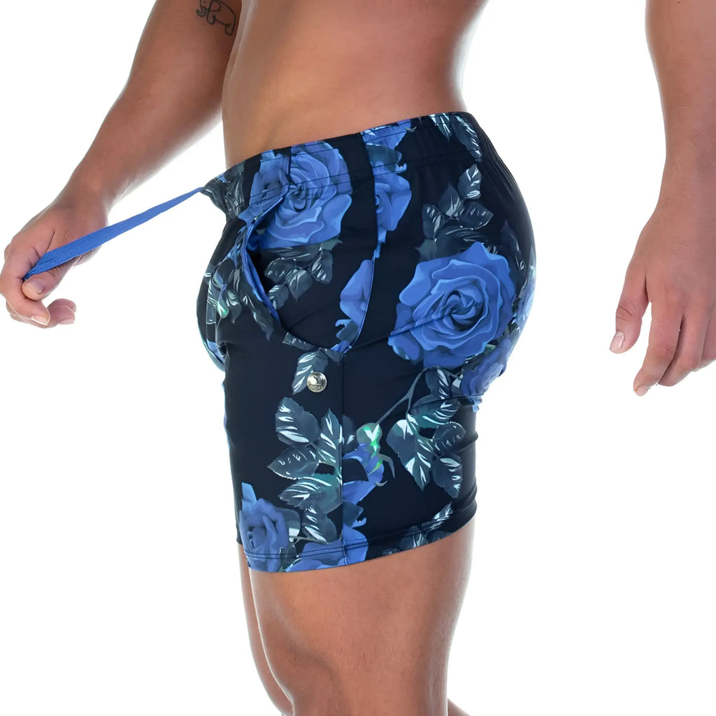 Blue rose patterned athletic shorts with black base and metallic button closure from gigo rose blue beachwear