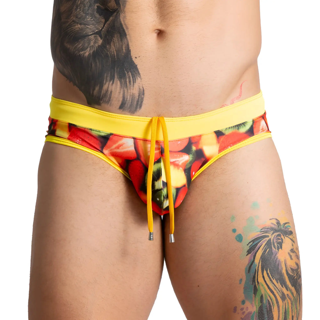 Bright yellow gigo salad swim brief swim trunks with colorful sliced strawberries and kiwi print for summer use