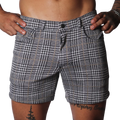 Black and white houndstooth print shorts with a subtle gold windowpane check, featuring a classic five-pocket design.
