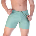 Mint green gigo traditional swim trunks with drawstring waistband designed for comfortable beachwear use