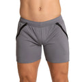 Gray athletic shorts with black zipper accents on the sides designed for training by gigo