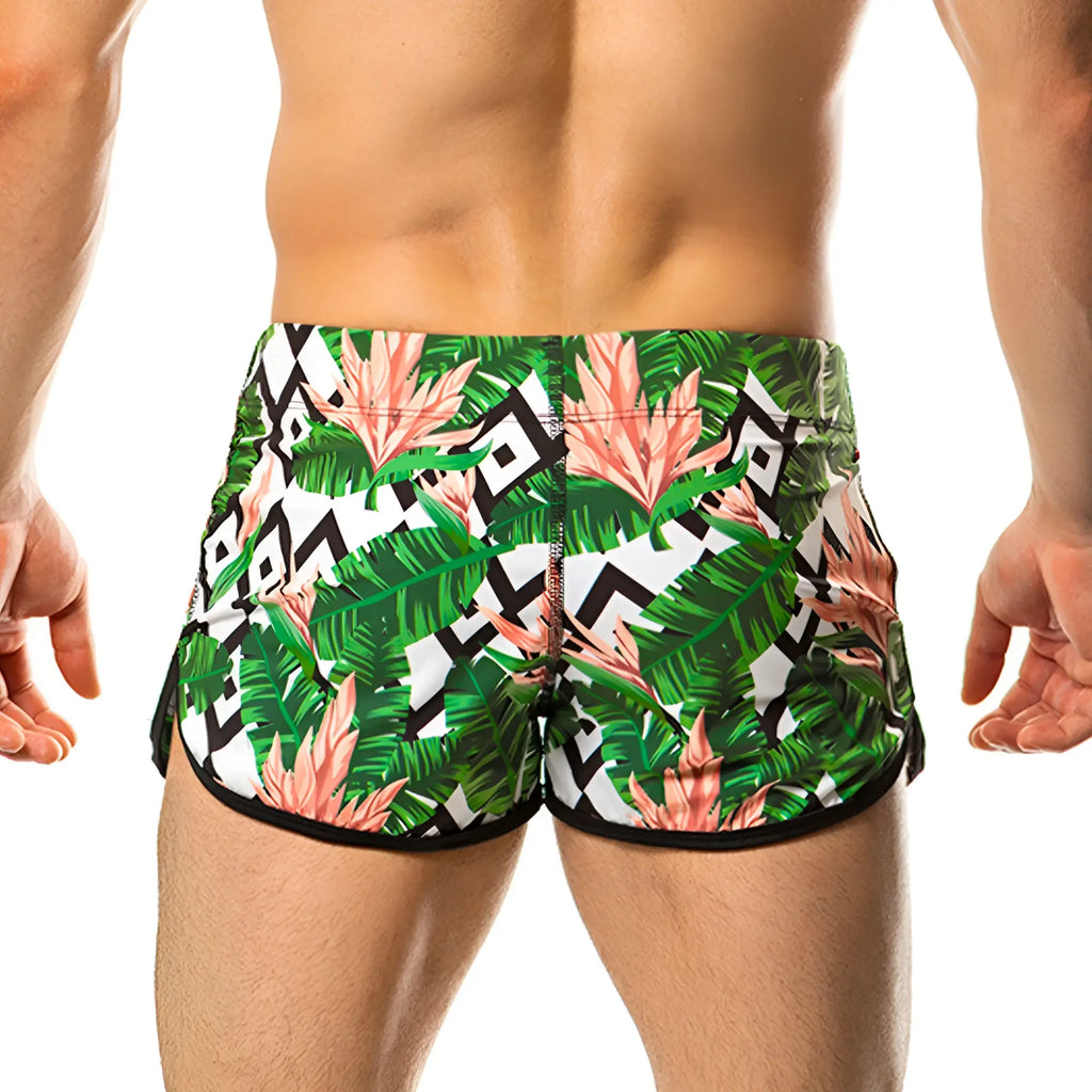 Gigo vintage beachwear tropical leaf and pink flower swim trunks with black geometric accents for men