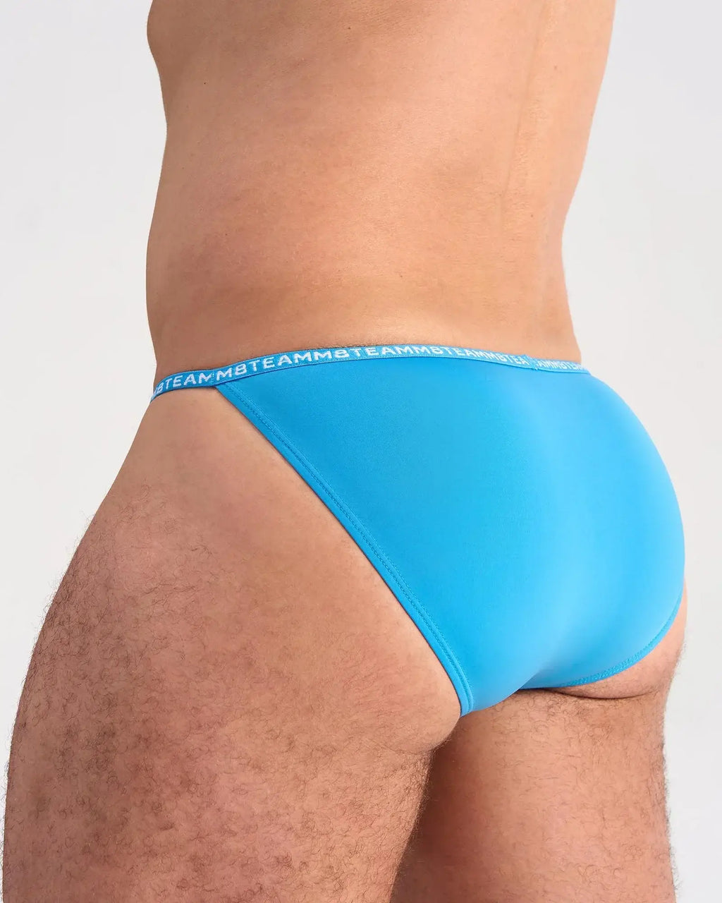 Bright blue glide micro brief with matching elastic waistband featuring repeating team logo in white