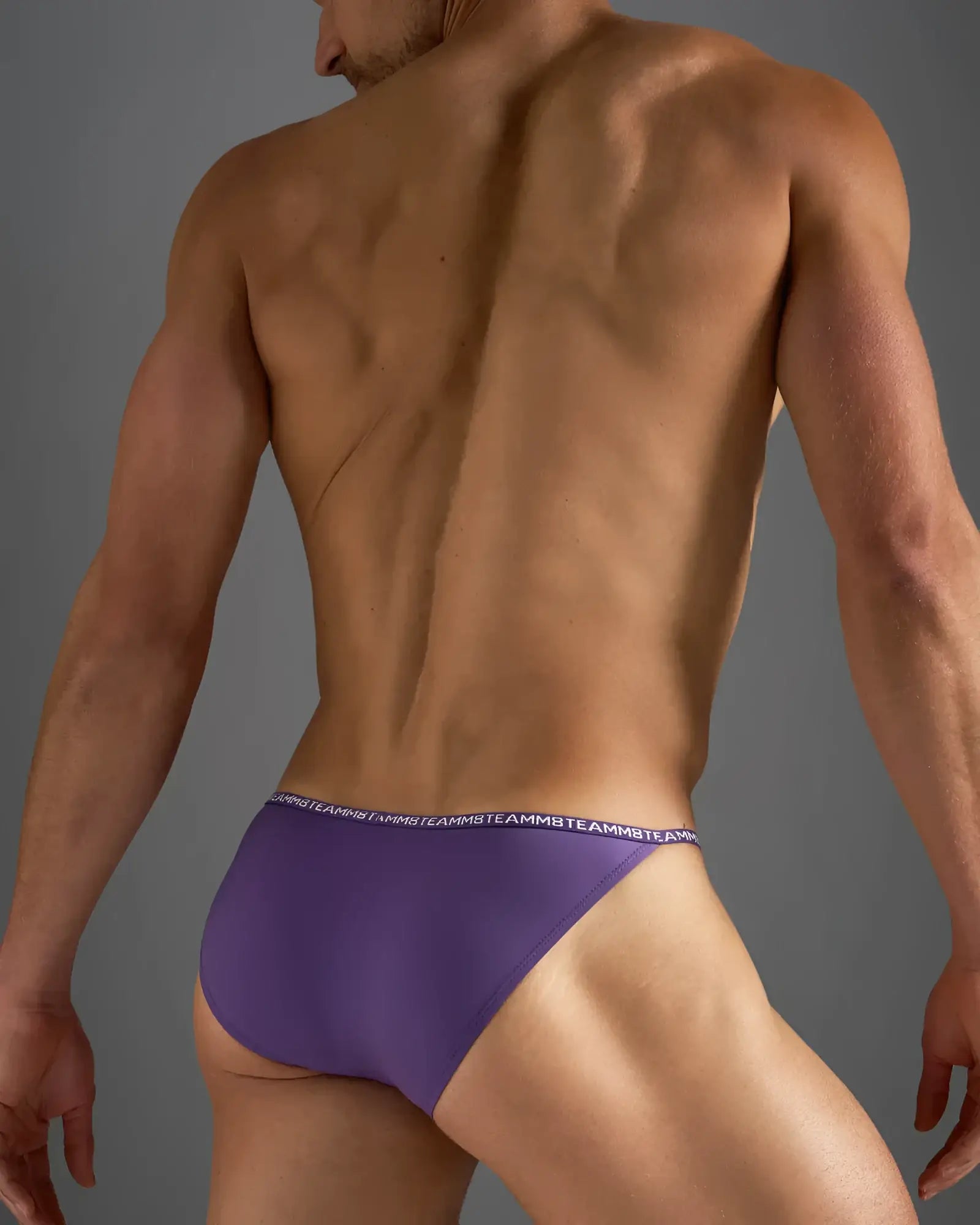 Purple glide micro brief athletic briefs with white repeating logo waistband designed for active wear