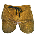 Gold glitter booty shorts with a black drawstring waistband made of sparkling fabric for festive wear