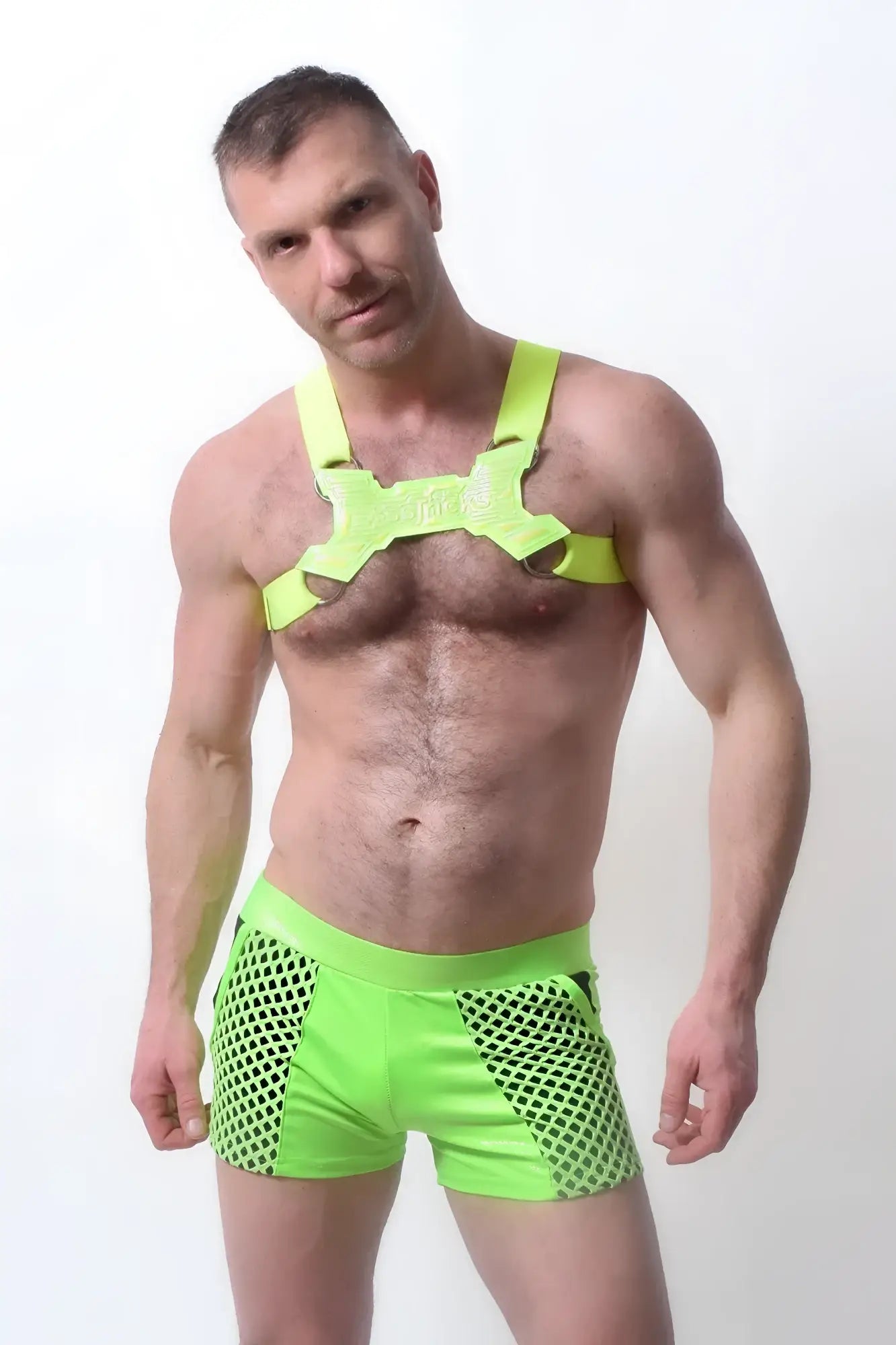 Bright neon green mesh glowtime shorts with a matching harness-style top perfect for vibrant summer wear