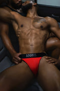 Red adonis branded goji berry night cap jock-thong briefs with black waistband shown from the back side