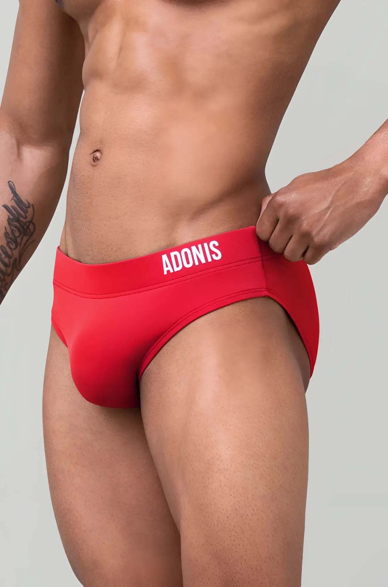 Red adonis goji berry swim brief with snug fit and white lettering on the waistband